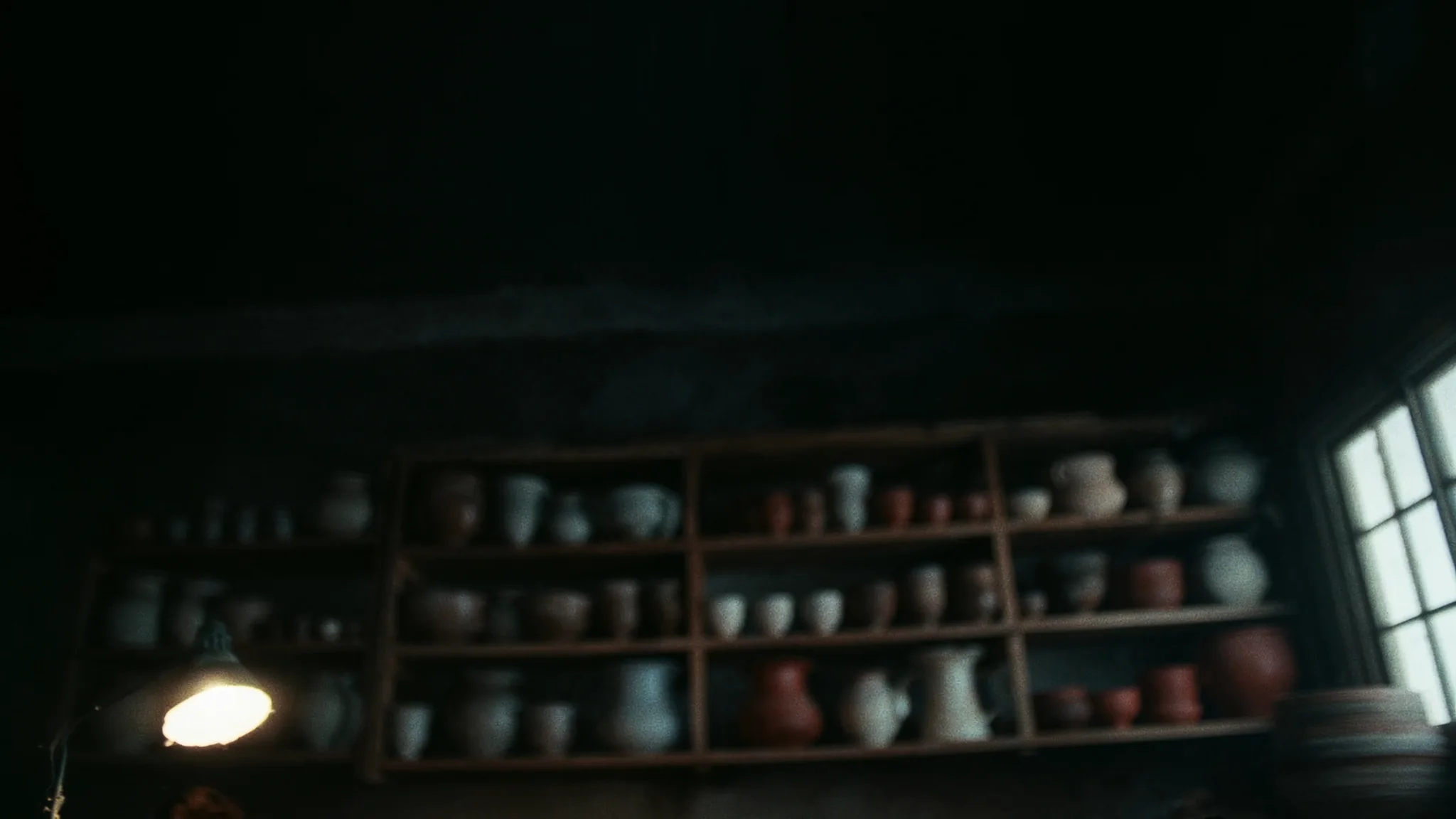 Open studio shelves lined with finished stoneware at dawn.